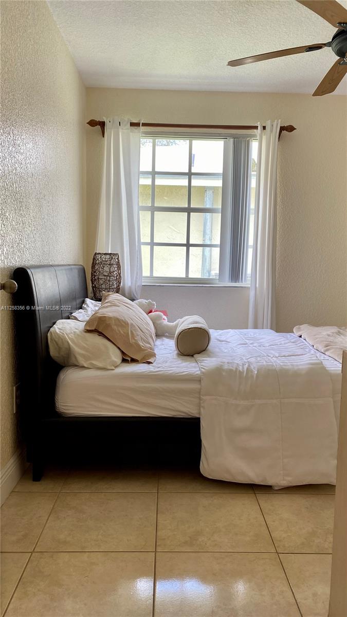 20309 Southwest 86th Court Cutler Bay, FL 33189 - Photo 48 of 59 a bedroom with bed and window