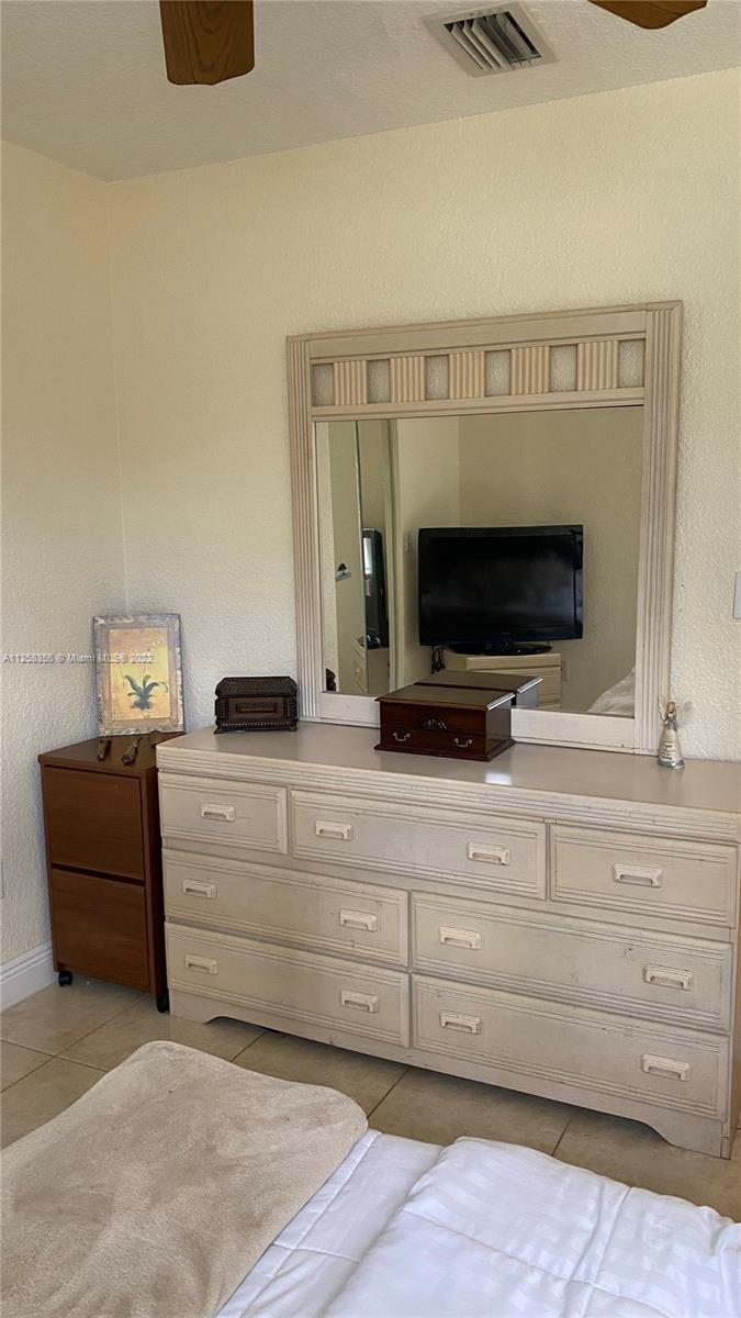 20309 Southwest 86th Court Cutler Bay, FL 33189 - Photo 50 of 59 a living room with furniture and a flat screen tv