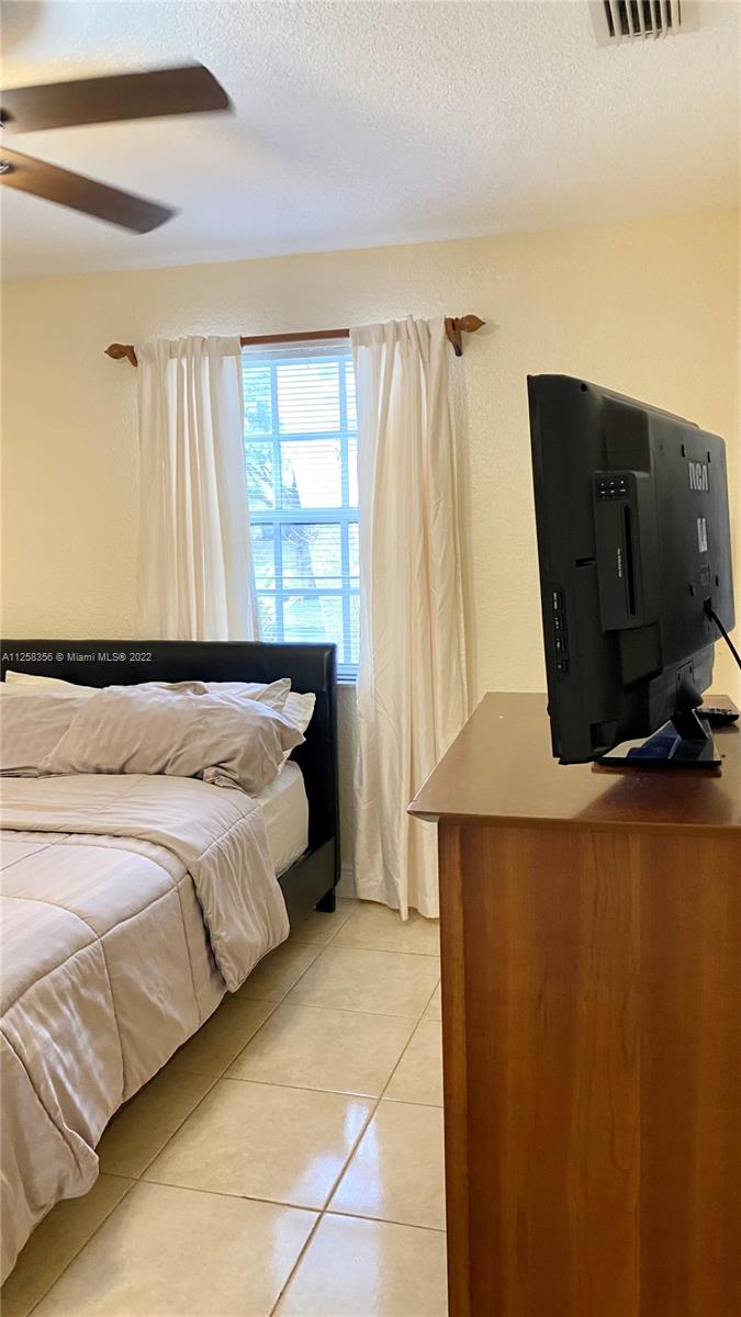 20309 Southwest 86th Court Cutler Bay, FL 33189 - Photo 53 of 59 a bedroom with a bed and a window