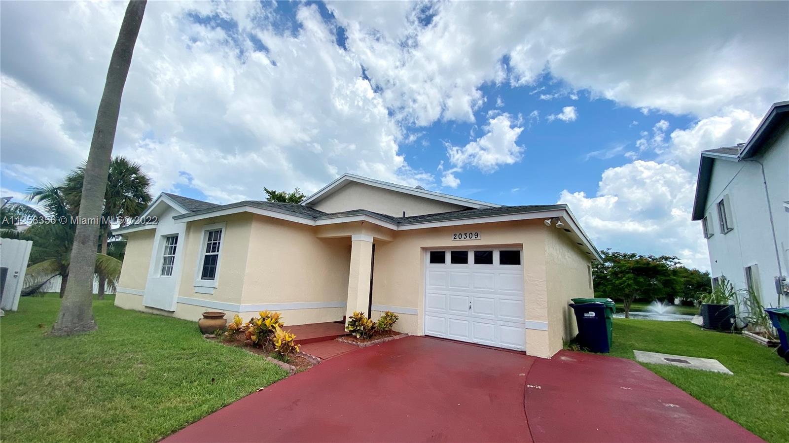 20309 Southwest 86th Court Cutler Bay, FL 33189 - Photo 55 of 59 a front view of a house with garden