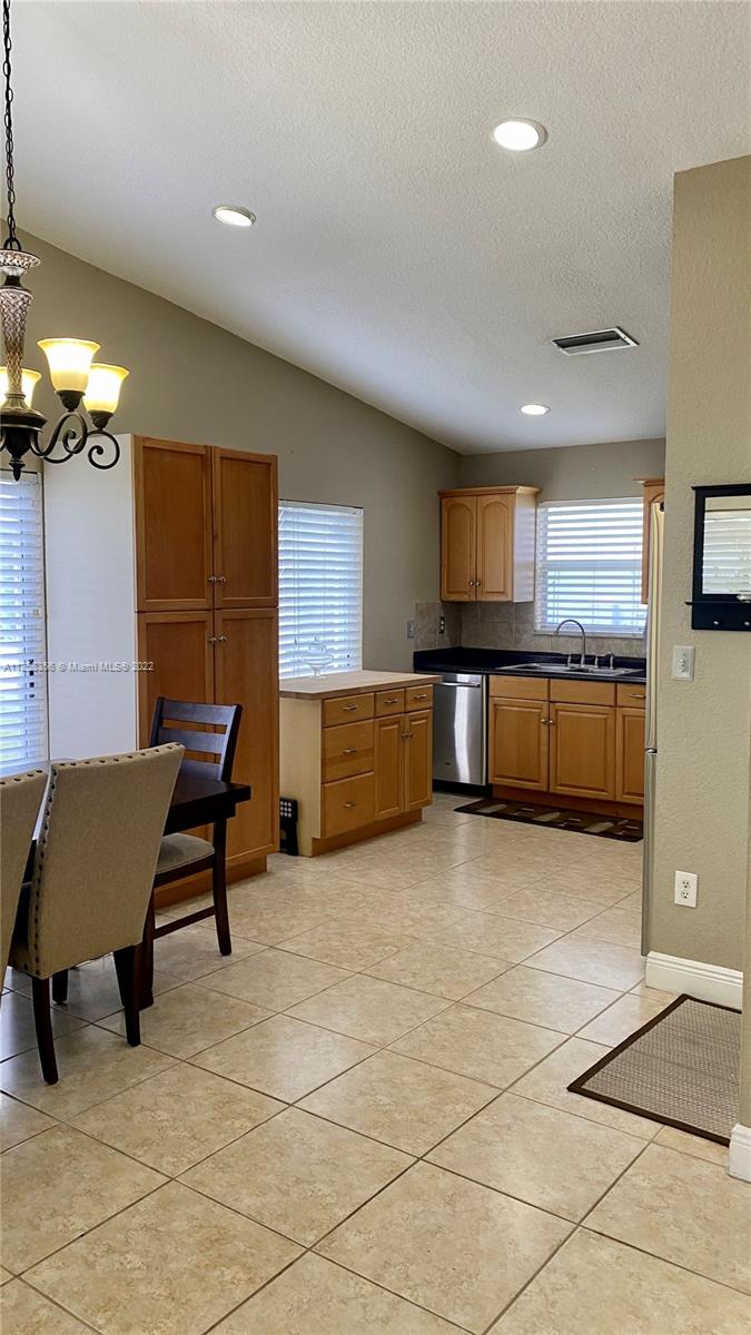 20309 Southwest 86th Court Cutler Bay, FL 33189 - Photo 10 of 59 a living room with furniture a dining table and kitchen view