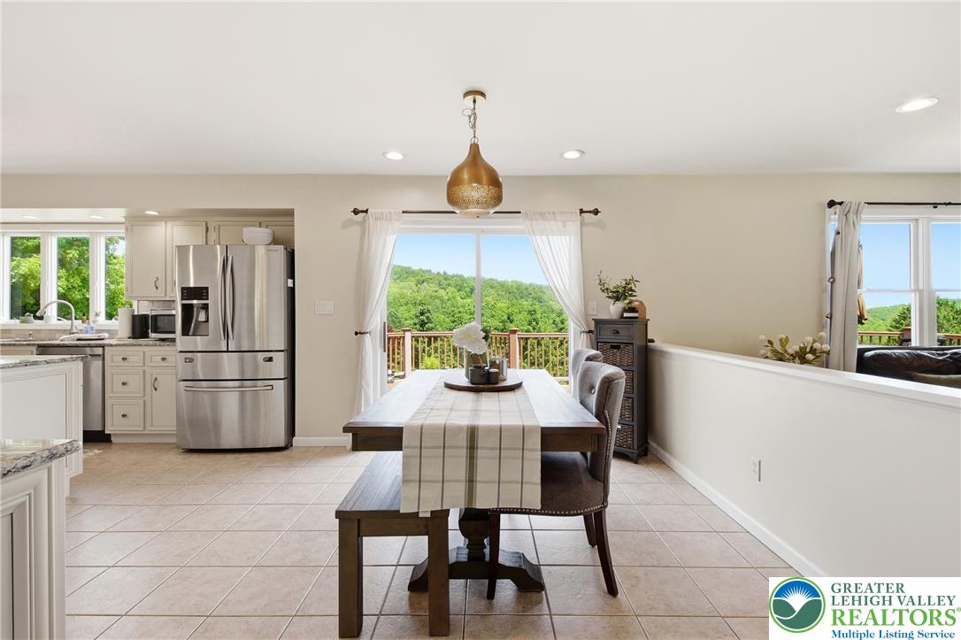 115 West Butternut Road Hellertown, PA 18055 - Photo 22 of 97 Hillside vistas fill the dining area, featuring an open-concept kitchen.