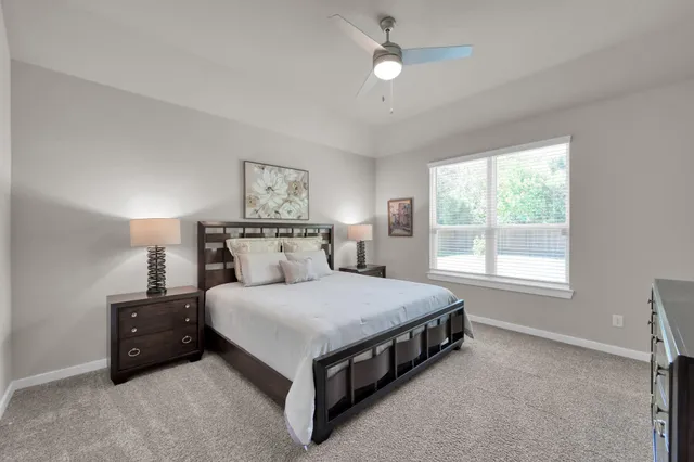 a bed sitting in a bedroom next to a window