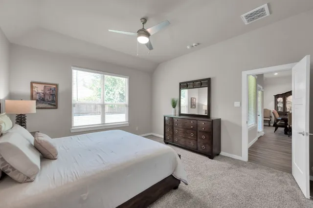 a bedroom with a bed and a chandelier
