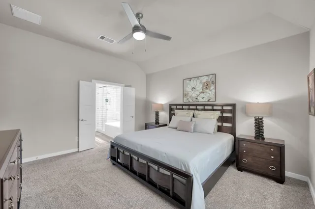 a bedroom with a bed and a night stand