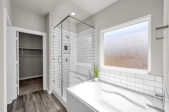 a bathroom with a bathtub and a shower