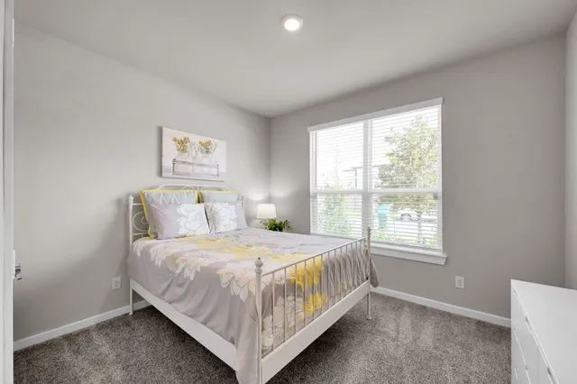 a bedroom with a bed and window