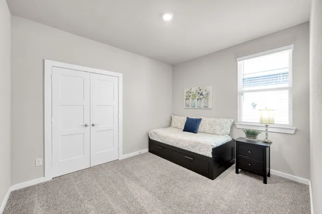 a bedroom with a bed and a window