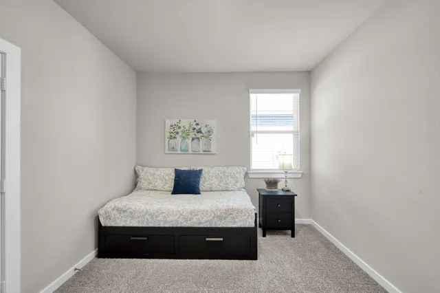 a bedroom with a bed and a window