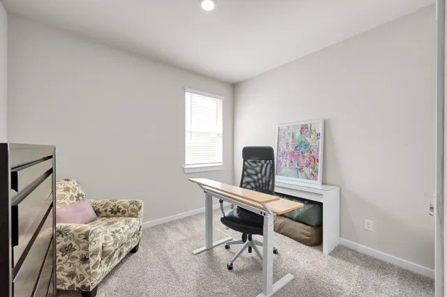 a bedroom with furniture and a window