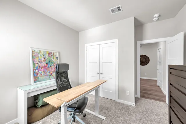 a view of a room with furniture and wooden floor
