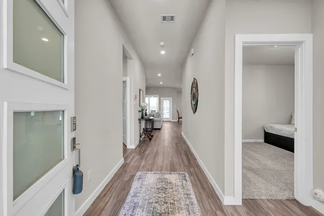 a view of a hallway view with wooden floor and staircase