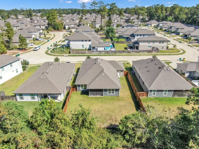 an aerial view of residential houses with outdoor space and swimming pool