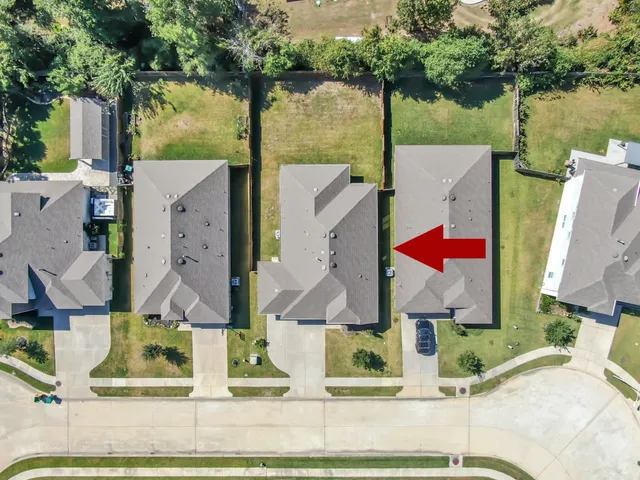an aerial view of houses with yard