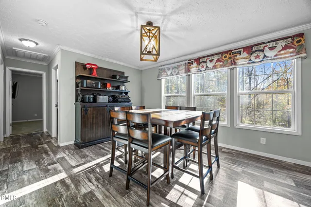 a view of a dining room with furniture window and outside view