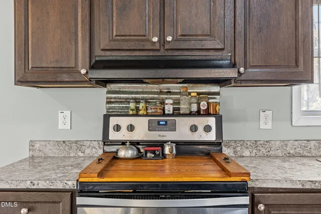 a room with kitchen countertops and wooden cabinets