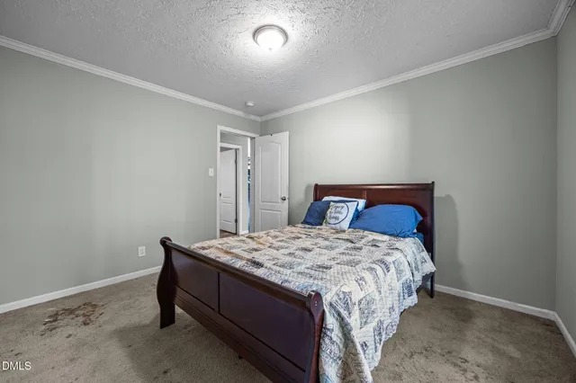 a bedroom with a bed and a table