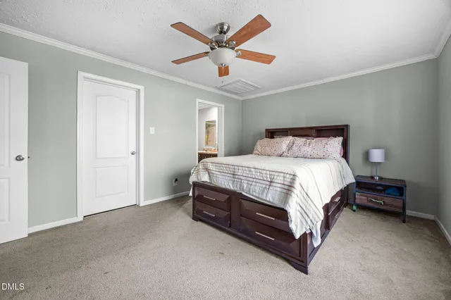 a spacious bedroom with a bed and ceiling fan