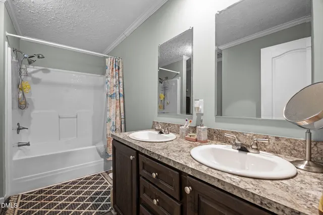 a bathroom with a granite countertop sink a mirror a shower and a bathtub