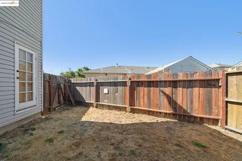 a view of a house with wooden fence