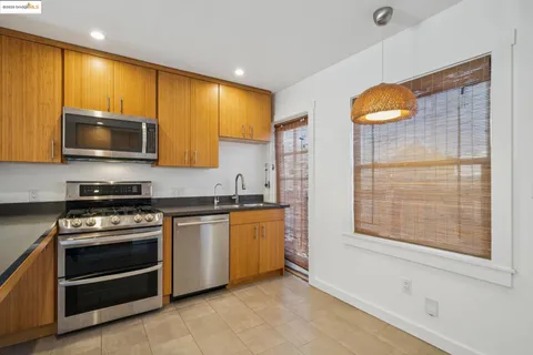 a kitchen with stainless steel appliances a stove a sink and a microwave