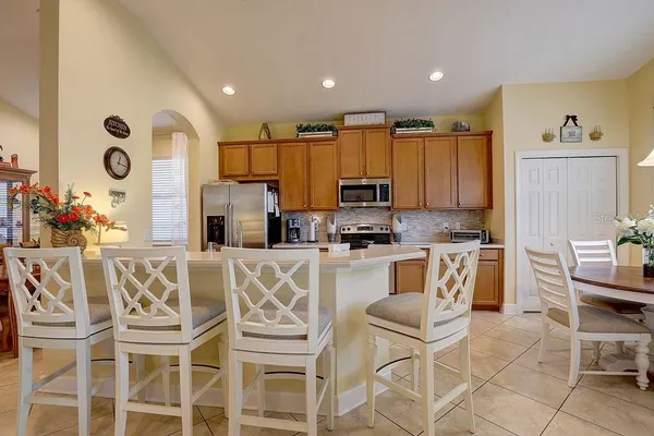 a kitchen with stainless steel appliances granite countertop a stove a sink and a microwave