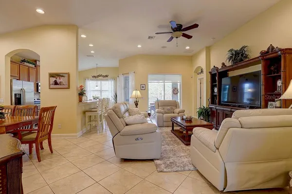 a living room with furniture and view of kitchen