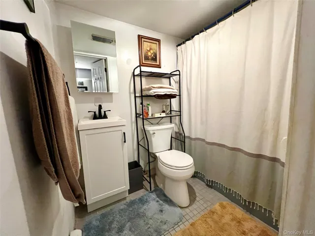 a bathroom with a toilet a sink and a shower