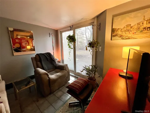 a living room with furniture and a floor to ceiling window