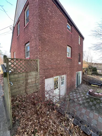 a brick building with a bench in front of it