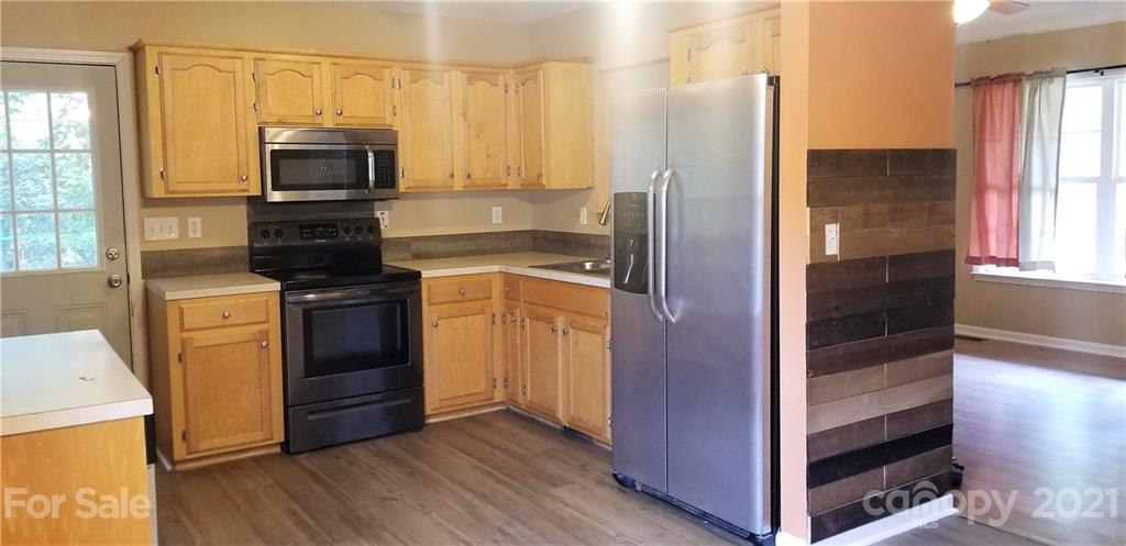 1202 West Rebound Road Lancaster, SC 29720 - Photo 5 of 14 a kitchen with a refrigerator stove and microwave