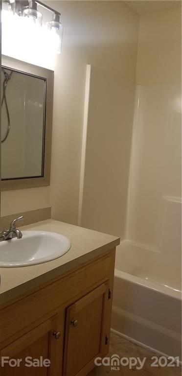 1202 West Rebound Road Lancaster, SC 29720 - Photo 10 of 14 a bathroom with a sink a bathtub and a mirror