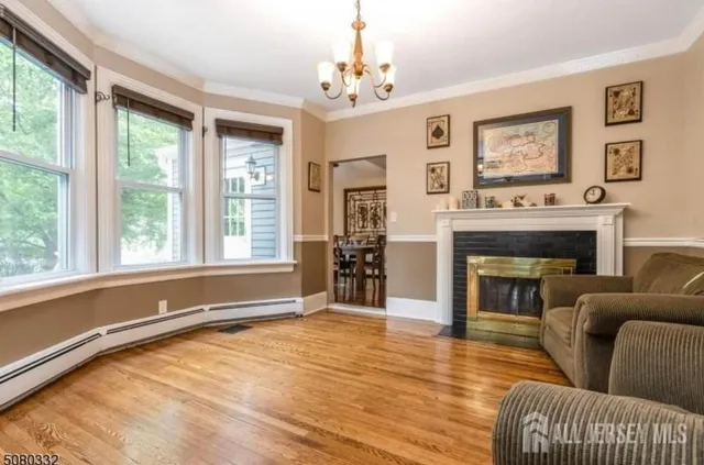 a living room with furniture a large window and a fireplace