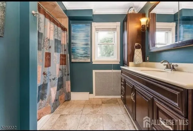 a bathroom with a sink a mirror and a shower