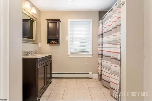 a bathroom with a sink a vanity and a mirror