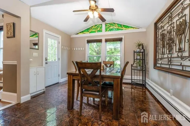 a dining room with furniture a chandelier and wooden floor