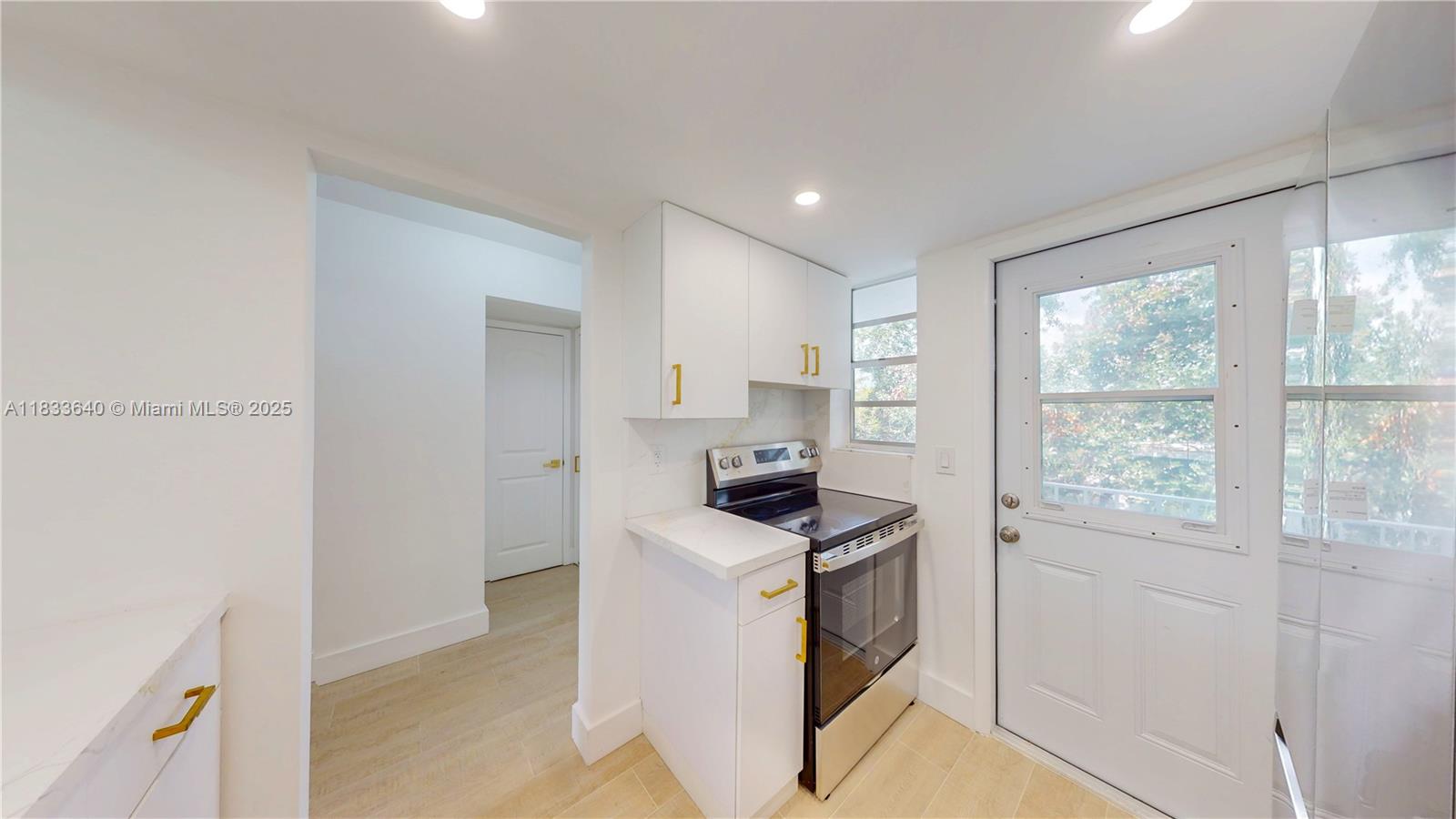 1333 East Hallandale Beach Boulevard, Unit 326 Hallandale Beach, FL 33009 - Photo 17 of 38 a kitchen that has a stove and a refrigerator
