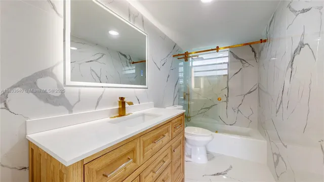 a large white kitchen with a sink a stove and refrigerator