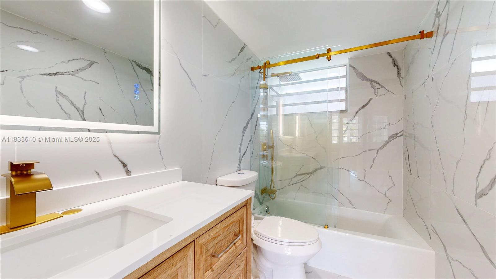 1333 East Hallandale Beach Boulevard, Unit 326 Hallandale Beach, FL 33009 - Photo 23 of 38 a bathroom with a sink a toilet and a bathtub