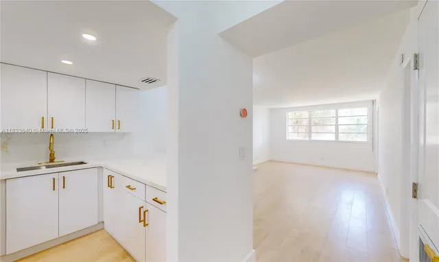 a kitchen that has a sink and a stove in it
