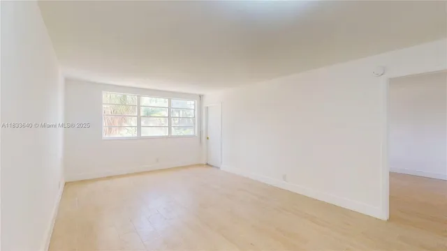 a kitchen with white cabinets stove and sink