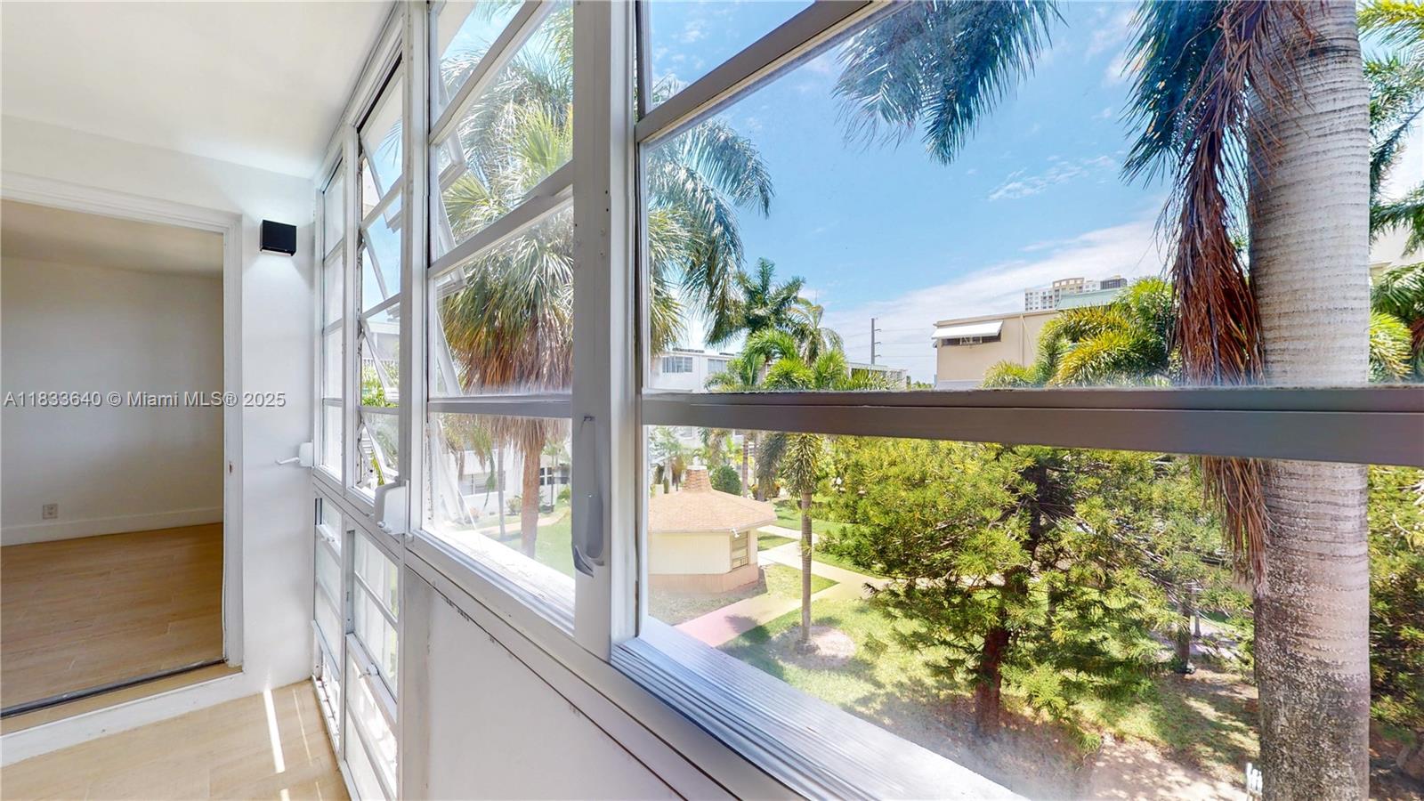 1333 East Hallandale Beach Boulevard, Unit 326 Hallandale Beach, FL 33009 - Photo 34 of 38 a view of a garden from a window