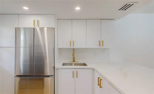 a kitchen with a refrigerator and cabinets