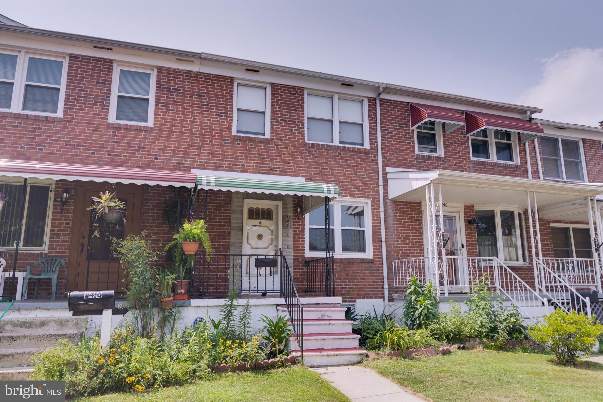 148 Wiltshire Road Baltimore, MD 21221 - Photo 3 of 28 front view of a brick house with a yard