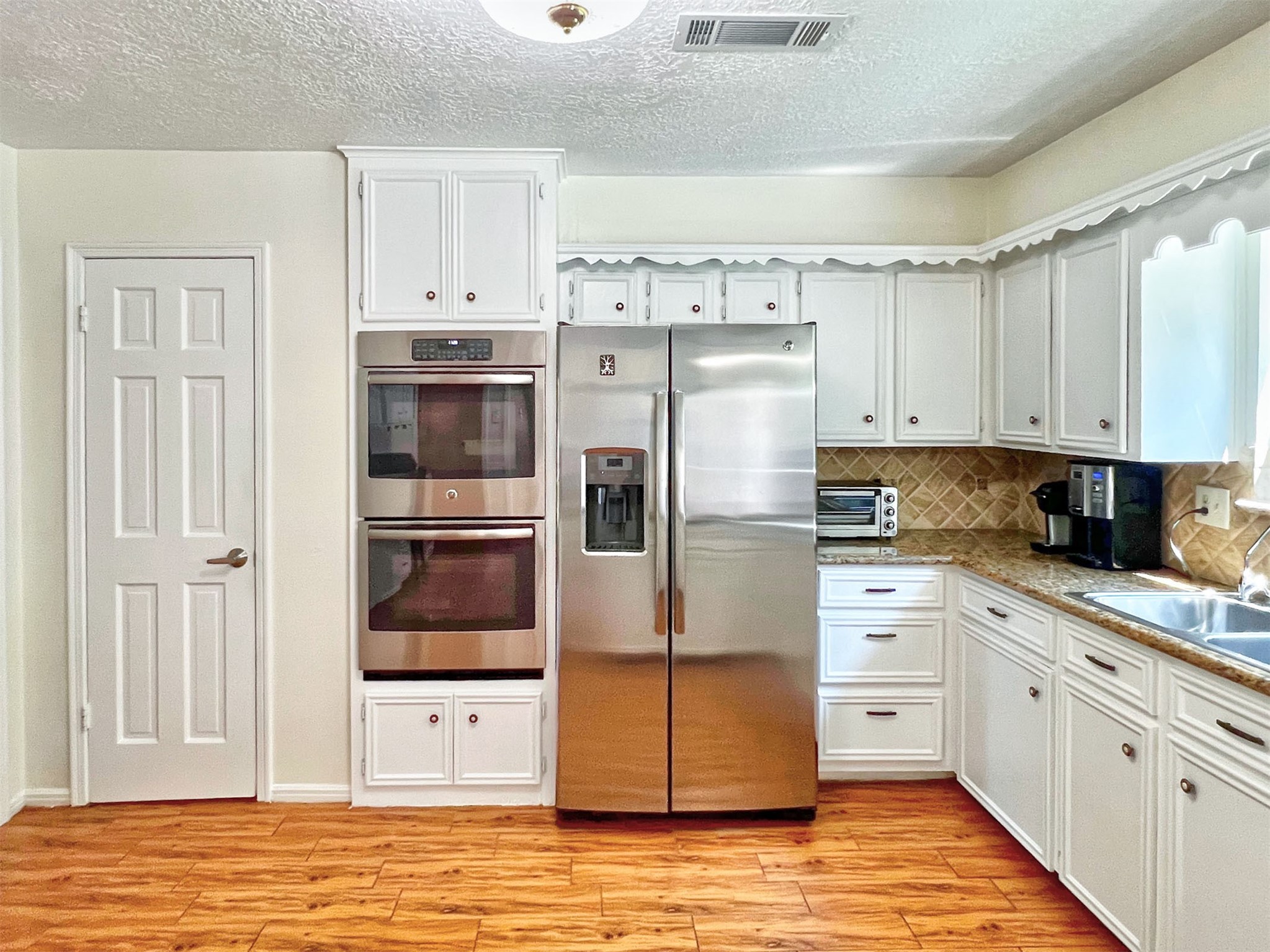 16902 Summit Oaks Lane Spring, TX 77379 - Photo 24 of 49 a kitchen with stainless steel appliances a refrigerator sink and cabinets