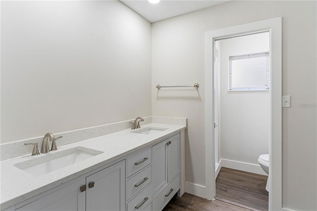 616 Water Road Ocala, FL 34472 - Photo 12 of 32 a bathroom with a granite countertop sink a toilet and a vanity