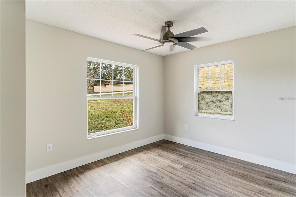 616 Water Road Ocala, FL 34472 - Photo 22 of 32 a view of an empty room with wooden floor and a window