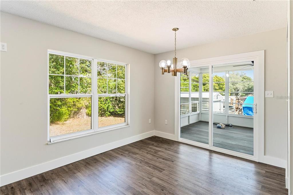 616 Water Road Ocala, FL 34472 - Photo 6 of 32 a view of an empty room with wooden floor and a window