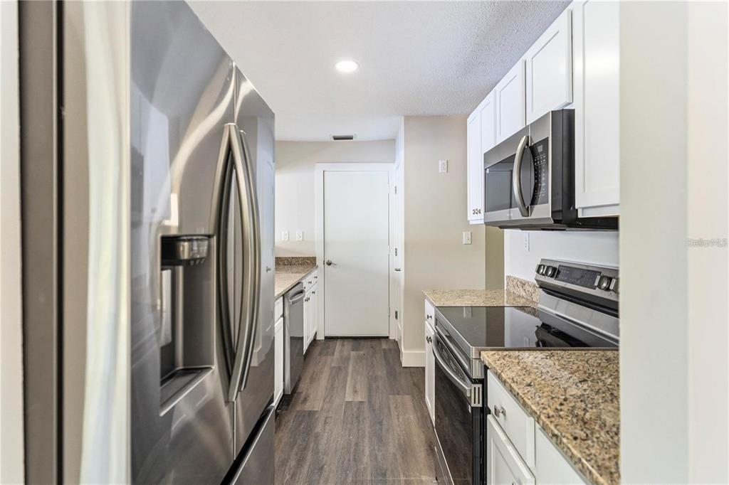 616 Water Road Ocala, FL 34472 - Photo 7 of 32 a kitchen with stainless steel appliances granite countertop a refrigerator and a stove top oven