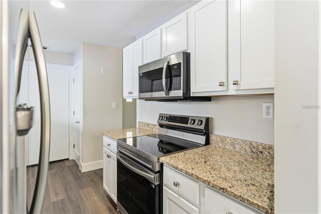 616 Water Road Ocala, FL 34472 - Photo 8 of 32 a kitchen with stainless steel appliances granite countertop a stove microwave and refrigerator